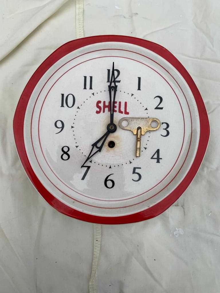 Lot 56 - OLD SHELL WALL CLOCK