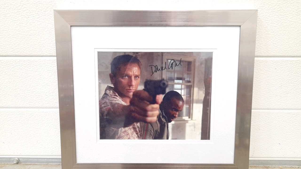 Lot 603 - FRAMED PHOTO SIGNED BY DANIEL CRAIG AS JAMES BOND 16"X14"