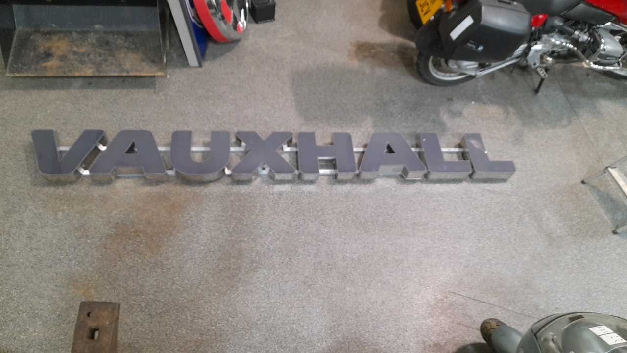 Lot 411 - GREY/ CHROME  LONG VAUXHALL DEALER SIGN  120" X 13"