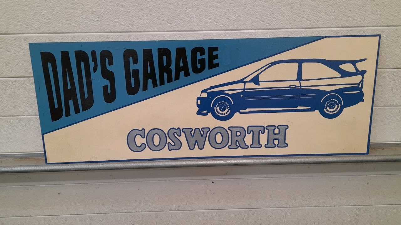 Click for high resolution Lot 145 - WOODEN HAND PAINTED DAD'S GARAGE  COSWORTH  SIGN  39" X 14"