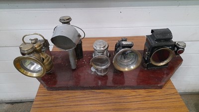 Lot 340 - SELECTION OF OLD STYLE CAR LAMPS ON WOODEN BOARD