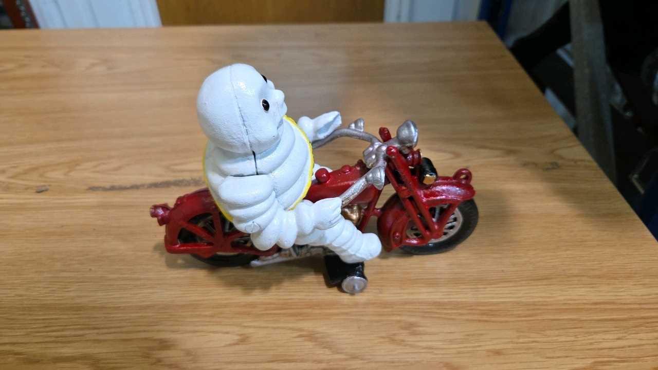 Lot 691 - CAST MICHELIN MAN ON A MOTOR BIKE 8" X 6"