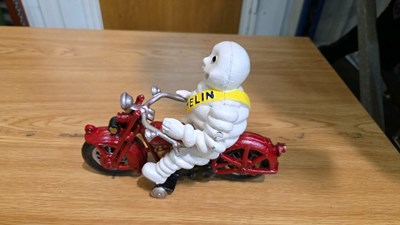 Lot 691 - CAST MICHELIN MAN ON A MOTOR BIKE 8" X 6"