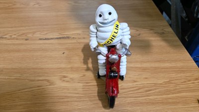 Lot 691 - CAST MICHELIN MAN ON A MOTOR BIKE 8" X 6"