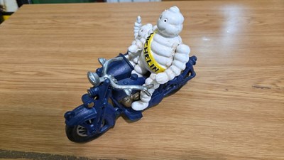 Lot 693 - CAST MICHELIN MEN ON A MOTOR BIKE & SIDECAR 8" X 6"