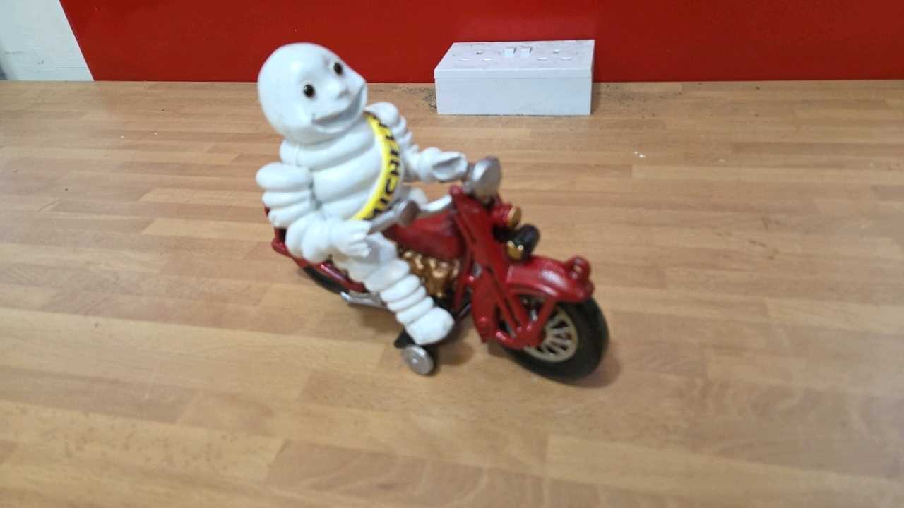 Lot 165 - CAST IRON MICHELIN MAN ON A MOTOBIKE