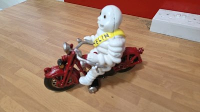 Lot 165 - CAST IRON MICHELIN MAN ON A MOTOBIKE