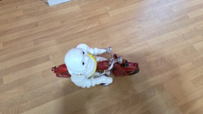 Lot 165 - CAST IRON MICHELIN MAN ON A MOTOBIKE