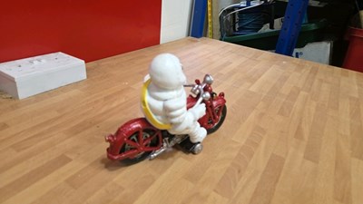 Lot 165 - CAST IRON MICHELIN MAN ON A MOTOBIKE