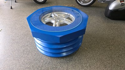 Lot 143 - CONCEPT COFFEE TABLE,IN THE FORM OF A NUT & THREAD, ROUND A PORSCHE WHEEL