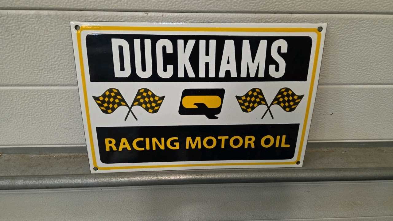 Lot 281 - DUCKHAMS RACING MOTOR OIL ENAMEL SIGN 15" X 12"