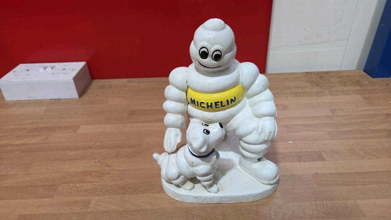 Lot 239 - CAST MICHELIN MAN & DOG 9" TALL