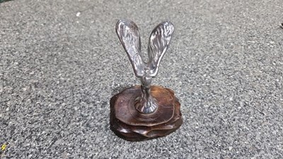 Lot 747 - SMALL ROLLS ROYCE SPIRIT OF ECSTASY ON WOODEN PLINTH