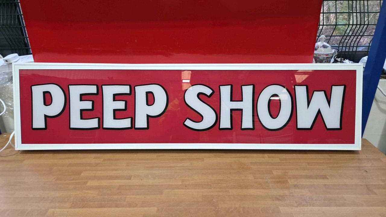Lot 109 - ILLUMINATED PEEP SHOW SIGN 47" X 12"
