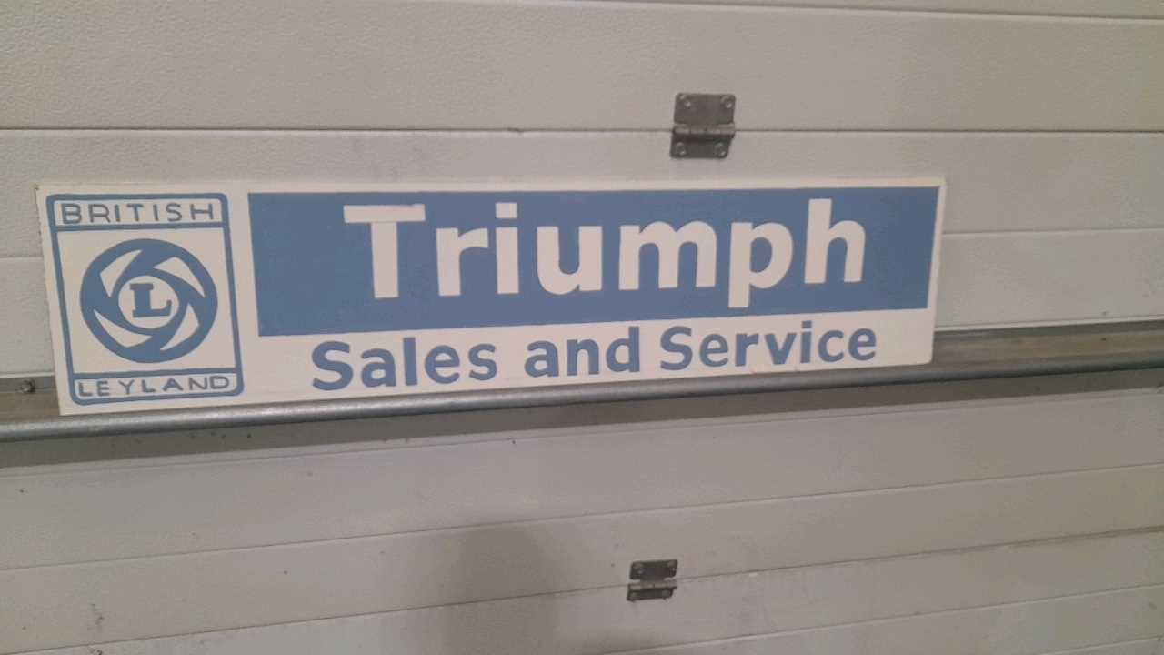 Lot 675 - WOODEN HAND PAINTED TRIUMPH SIGN