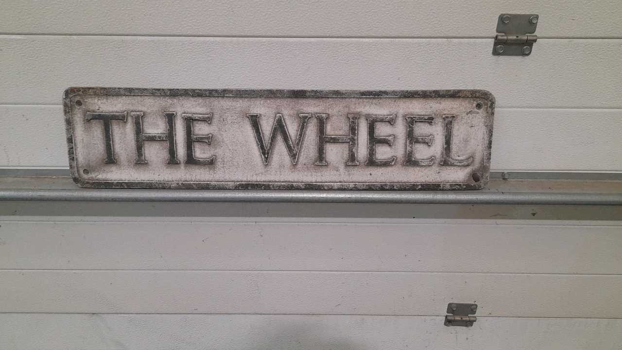 Lot 219 - THE WHEEL CAST ALUMINIUM SIGN